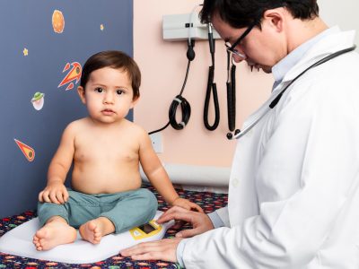 close-up-doctor-weighing-baby-boy